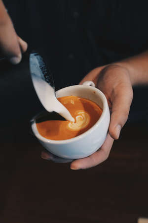 cup of coffee latte on the wood texture   in vintage color toneの写真素材