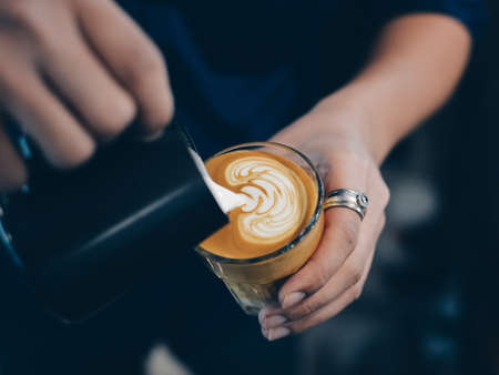 cup of coffee latte on the wood texture   in vintage color toneの写真素材
