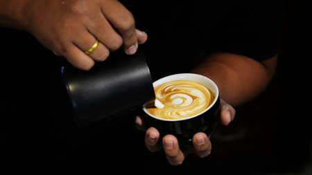 cup of coffee latte on the wood texture   in vintage color toneの写真素材