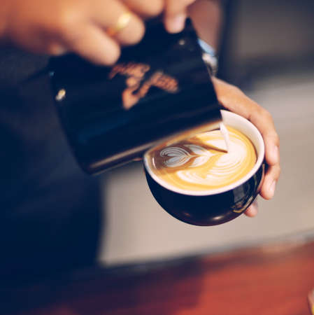 cup of coffee latte on the wood texture   in vintage color toneの写真素材