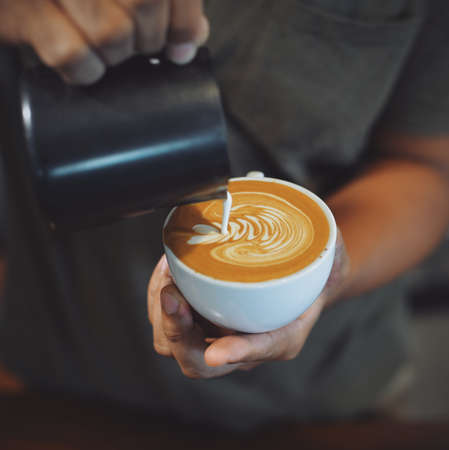 cup of coffee latte on the wood texture   in vintage color toneの写真素材
