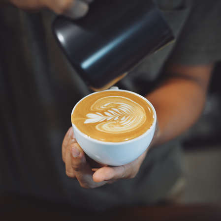 cup of coffee latte on the wood texture   in vintage color toneの写真素材