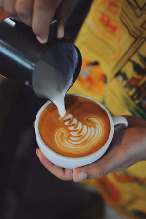 cup of coffee latte on the wood texture   in vintage color toneの写真素材