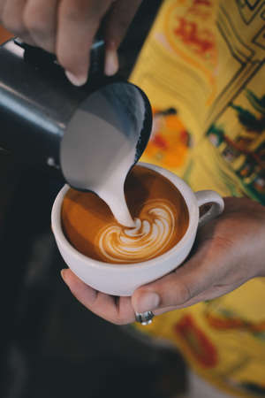 cup of coffee latte on the wood texture   in vintage color toneの写真素材