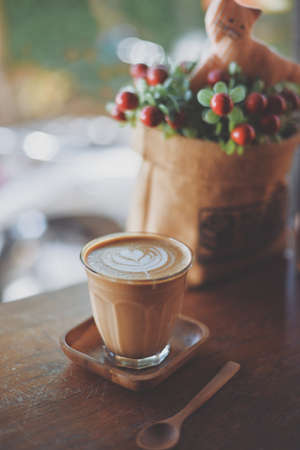 cup of coffee latte on the wood texture   in vintage color toneの写真素材