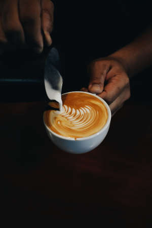 cup of coffee latte on the wood texture   in vintage color toneの写真素材