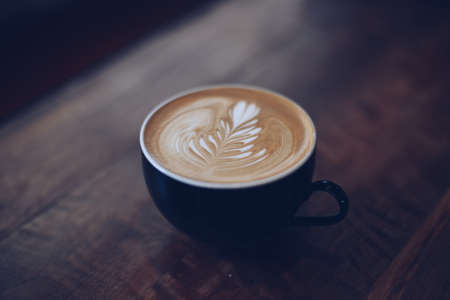 vintage color tone of  cup of coffee latte artの写真素材