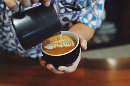 cup of coffee latte on the wood texture   in vintage color toneの写真素材