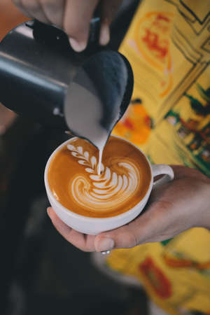 cup of coffee latte on the wood texture   in vintage color toneの写真素材