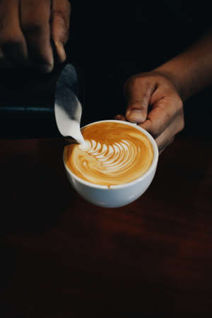 cup of coffee latte on the wood texture   in vintage color toneの写真素材