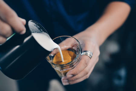 cup of coffee latte on the wood texture   in vintage color toneの写真素材