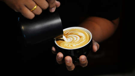 cup of coffee latte on the wood texture   in vintage color toneの写真素材