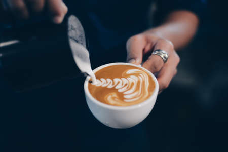 cup of coffee latte on the wood texture   in vintage color toneの写真素材