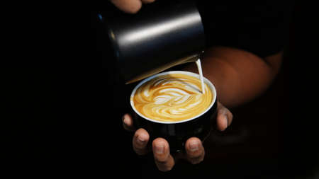 cup of coffee latte on the wood texture   in vintage color toneの写真素材