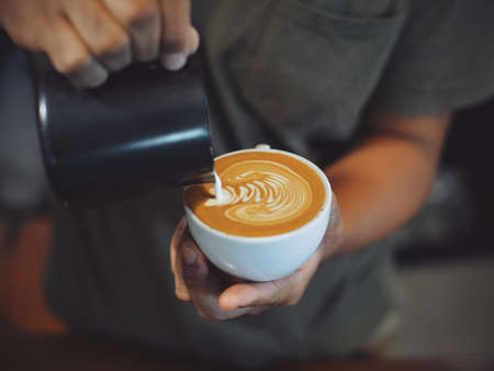 cup of coffee latte on the wood texture   in vintage color toneの写真素材