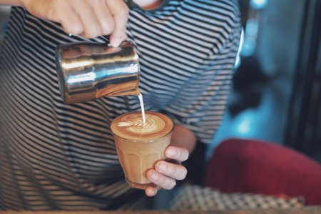 how to make coffee latte art in vintage color toneの写真素材