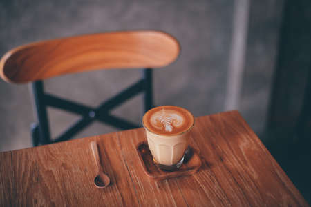 cup of coffee latte on the wood texture   in vintage color toneの写真素材