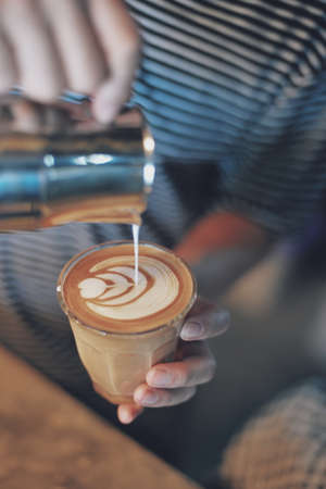 how to make coffee latte art in vintage color toneの写真素材