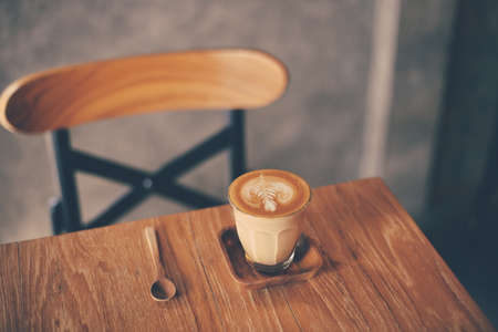 cup of coffee latte on the wood texture   in vintage color toneの写真素材