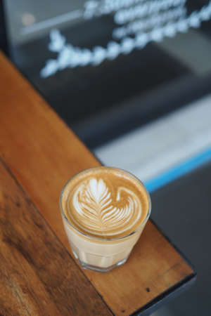 coffee latte art in coffee shop in vintage color tone
