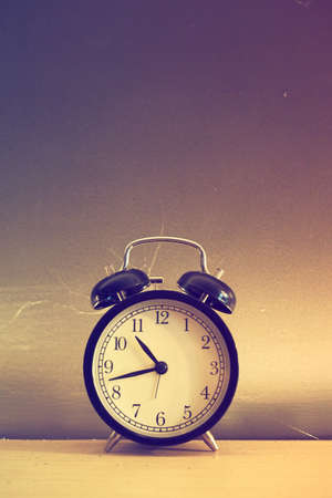 vintage alarm clock in vintage coloの写真素材