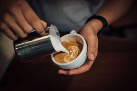 coffee latte art in coffee shop in vintage color toneの写真素材