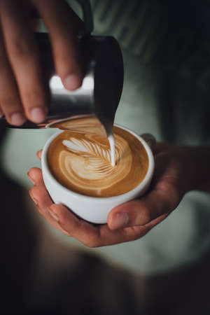coffee latte : coffee latte art make by coffee maker barista in coffee shop cafe with  vintage color toneの写真素材