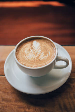 coffee latte art make by barista in coffee shop cafe vintage color toneの写真素材