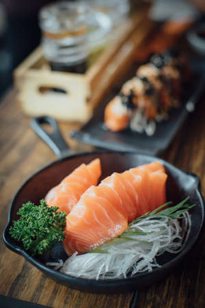 Salmon raw sashimi on wooden tableの写真素材