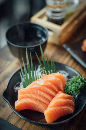 Salmon raw sashimi on wooden tableの写真素材