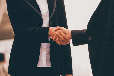 Two business woman talking together at outdoor.