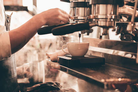 close up barista hand making a cup of coffee.の写真素材