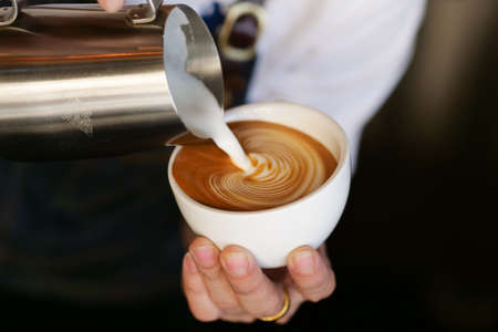 close up barista hand making a cup of coffee.の写真素材