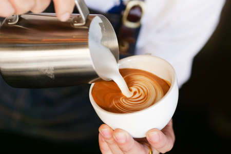 close up barista hand making a cup of coffee.の写真素材