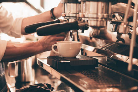 close up barista hand making a cup of coffee.の写真素材