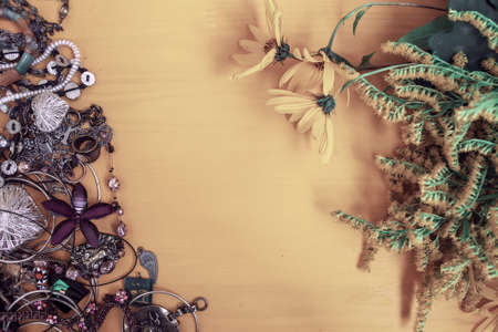 Jewels and yellow flowers on a yellow backgroundの写真素材