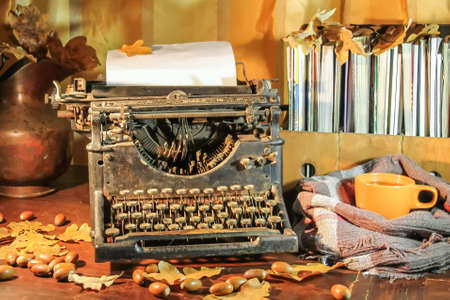 Old typewriter with autumn oak leaves and acorns, Retro still lifeの写真素材