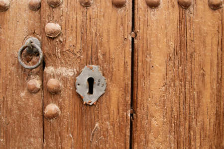 Old wooden door with keyhole. Andalusia Spain.の写真素材