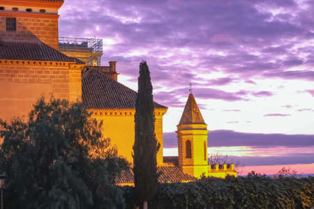 The setting sun illuminates the old building. Andalusia, Spain