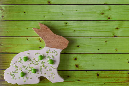 Easter bunny on a green wooden backgroundの写真素材
