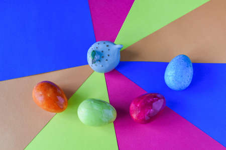 Gray chicken with four colorful easter eggs.の写真素材