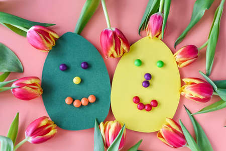 Yellow and green eggs with Funny Faces and red tulips.