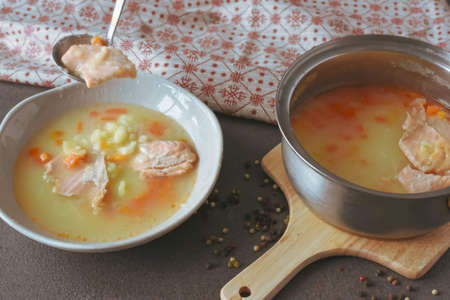 Salmon fish soup with vegetables and pepper