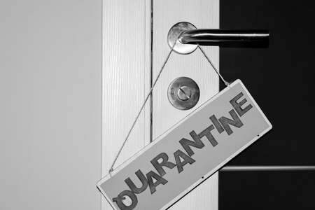 Handmade plate with the inscription Quarantine on the door of the apartment.の写真素材