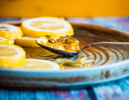 Vitamins needed in the spring - Vitamin C in lemon and fish oilの写真素材