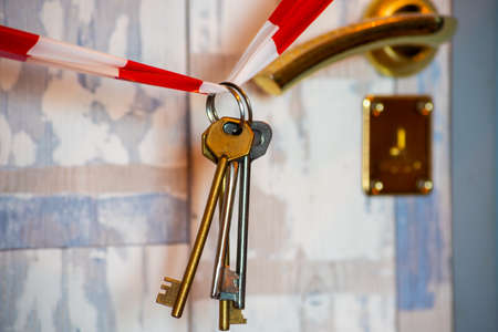 Keys and front door locked. Need to stay homeの写真素材
