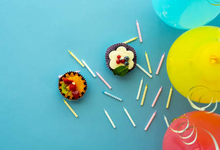 Delicious cakes with candles and colorful balloonsの写真素材
