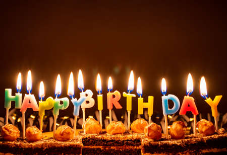 Happy Birthday - candles on brownies on a brown background.の写真素材
