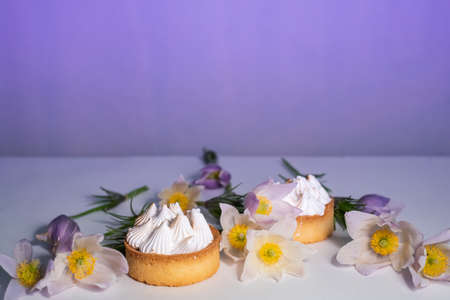 Delicate white flowers and pastries with white cream.の写真素材