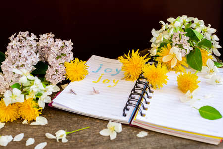 Apple tree dandelion lilac flowers and notebook.の写真素材